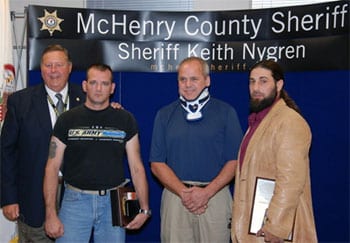 Sheriff Keith Nygren presents an award to James Halterman and Daniel Narcisco for saving the life of David Kieffer by cutting him free from a buring vehicle. Halterman used a Gerber Covert 154CM knife to cut Kieffer's seatbelt and then the pair pulled him